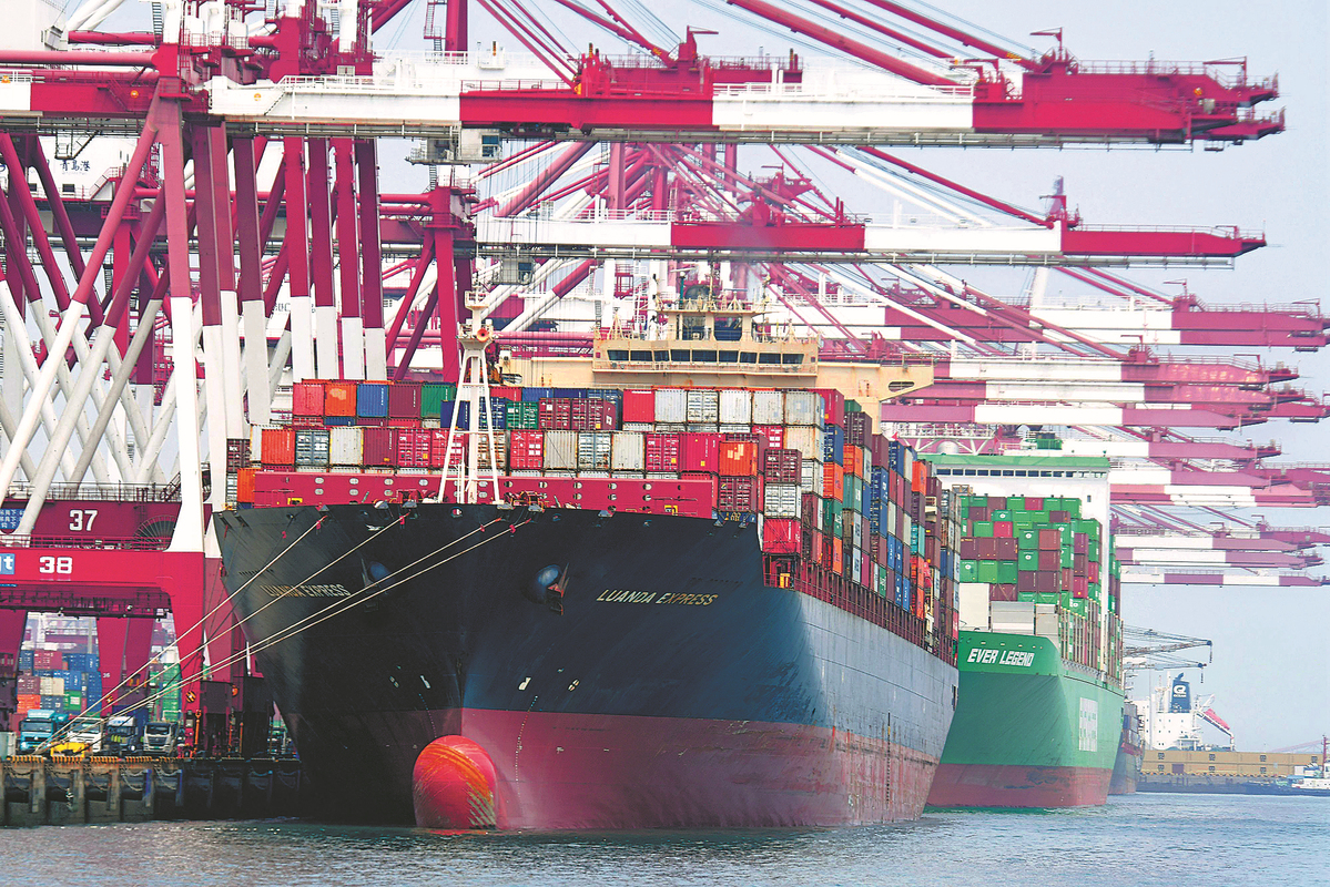 Container vessels unload cargo at a terminal in Qingdao, Shandong province, in August.